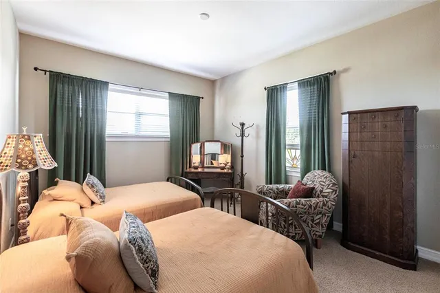 a bedroom with two beds and a dresser