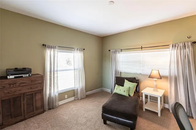 a view of a livingroom with workspace and a window