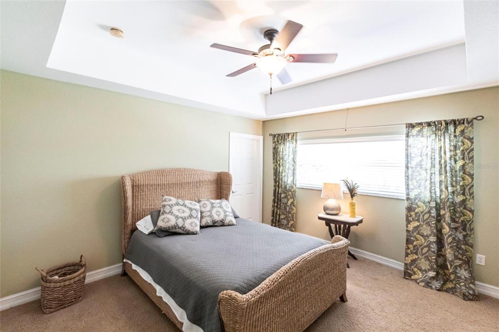 3712 Balboa Court Punta Gorda, FL 33983 - Photo 32 of 53 a bedroom with a bed and a chandelier