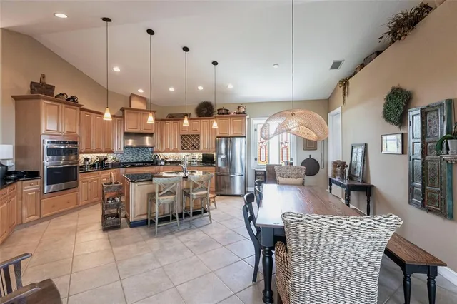 a large kitchen with a table and chairs