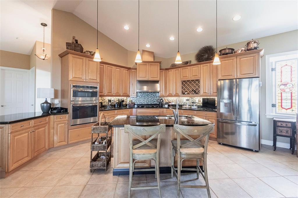 3712 Balboa Court Punta Gorda, FL 33983 - Photo 5 of 53 a kitchen with stainless steel appliances granite countertop a table chairs sink refrigerator and microwave