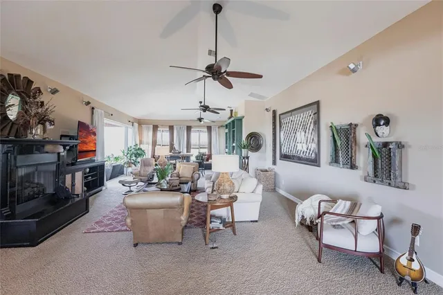 a living room with furniture a chandelier and a window