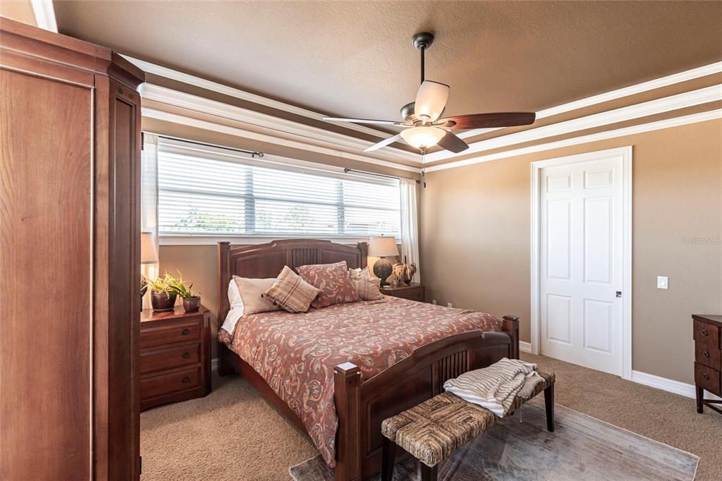 3712 Balboa Court Punta Gorda, FL 33983 - Photo 10 of 53 a bedroom with a bed and a chandelier