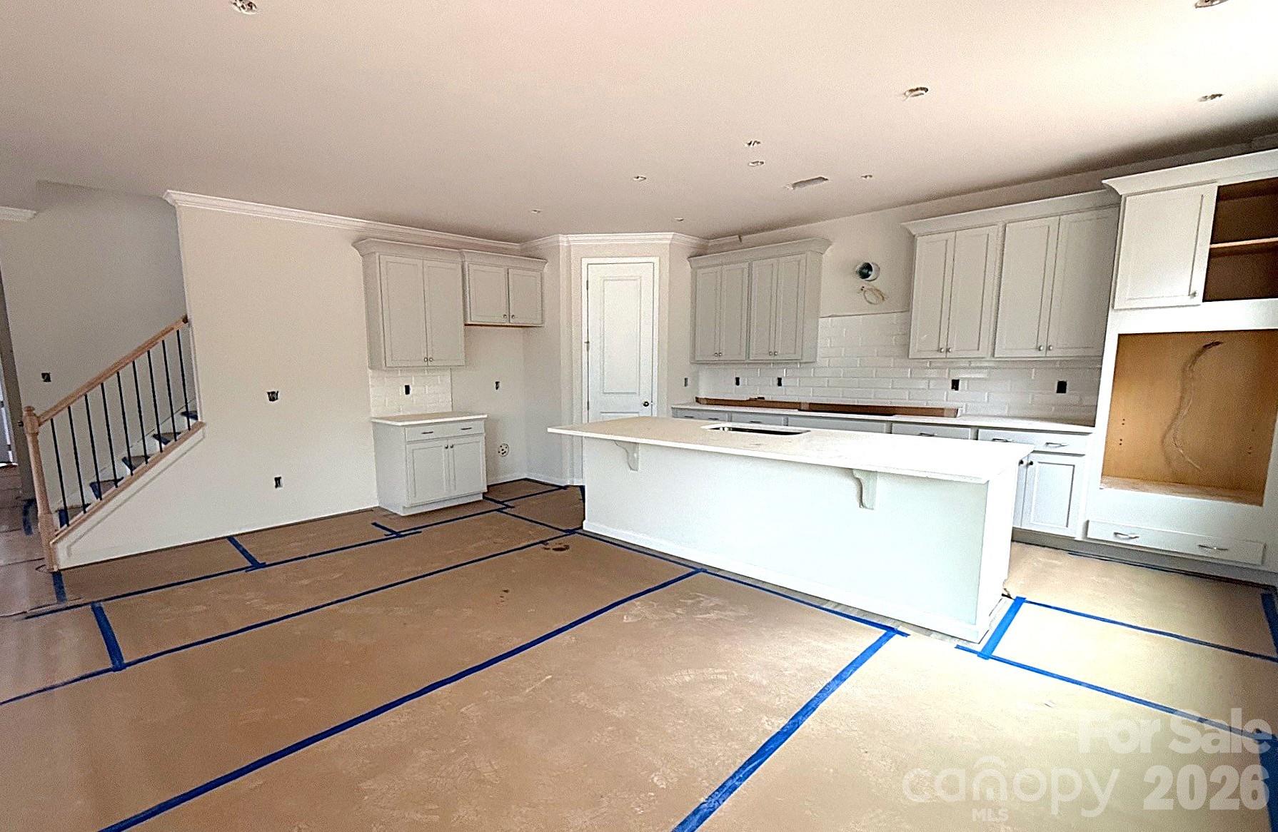 9969 Cask Way Huntersville, NC 28078 - Photo 12 of 36 a kitchen with white cabinets and white appliances