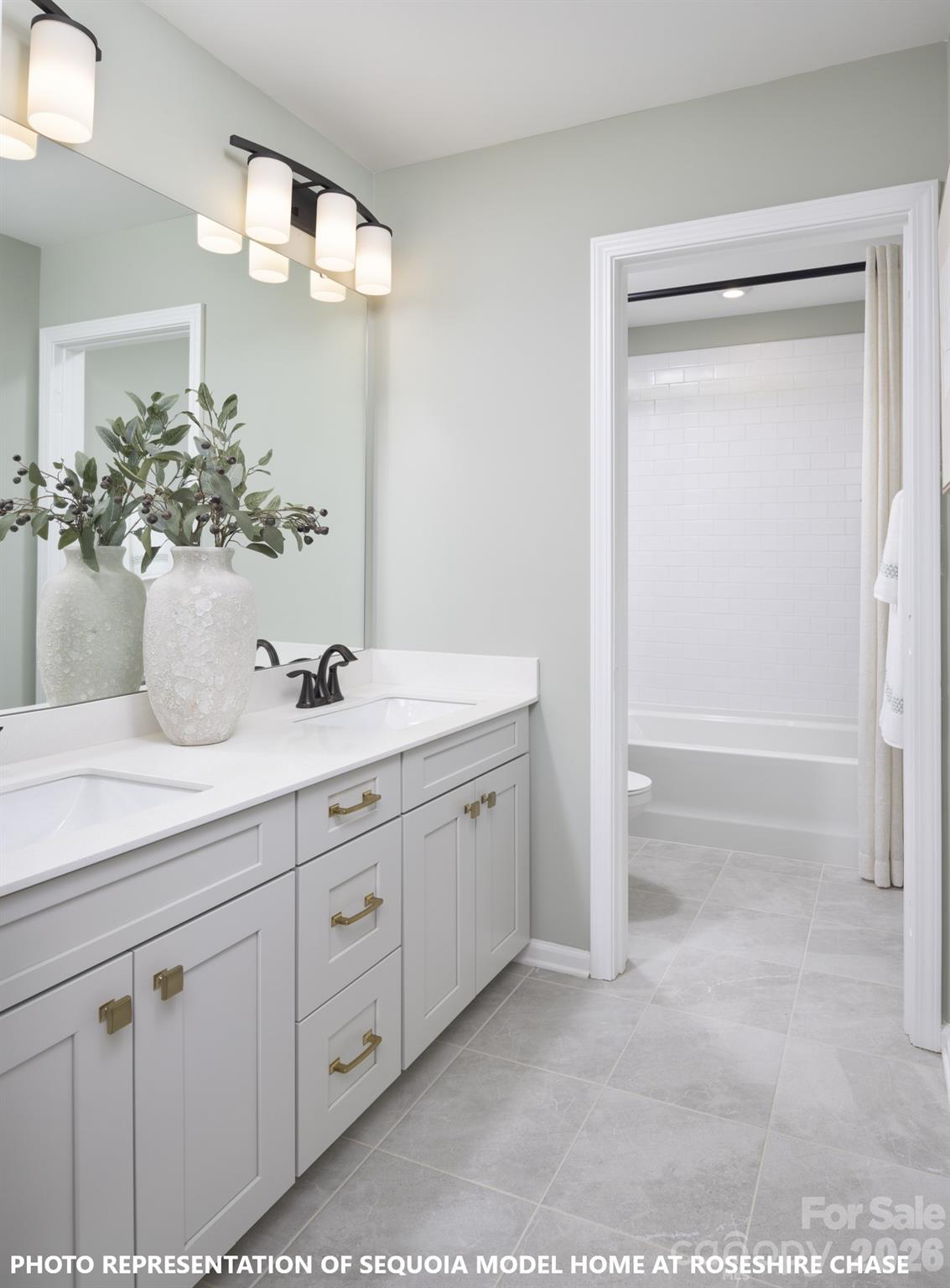 9969 Cask Way Huntersville, NC 28078 - Photo 25 of 36 a bathroom with a double vanity sink and a mirror