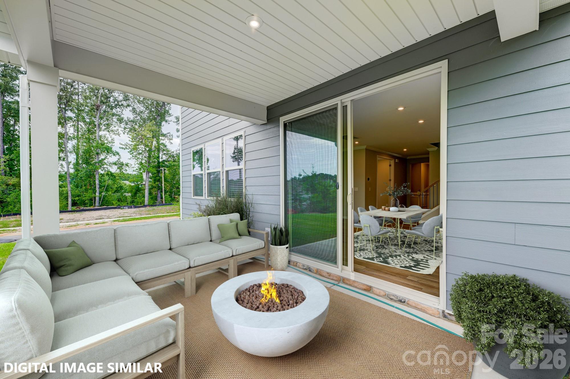 9969 Cask Way Huntersville, NC 28078 - Photo 34 of 36 a living room with furniture and a floor to ceiling window