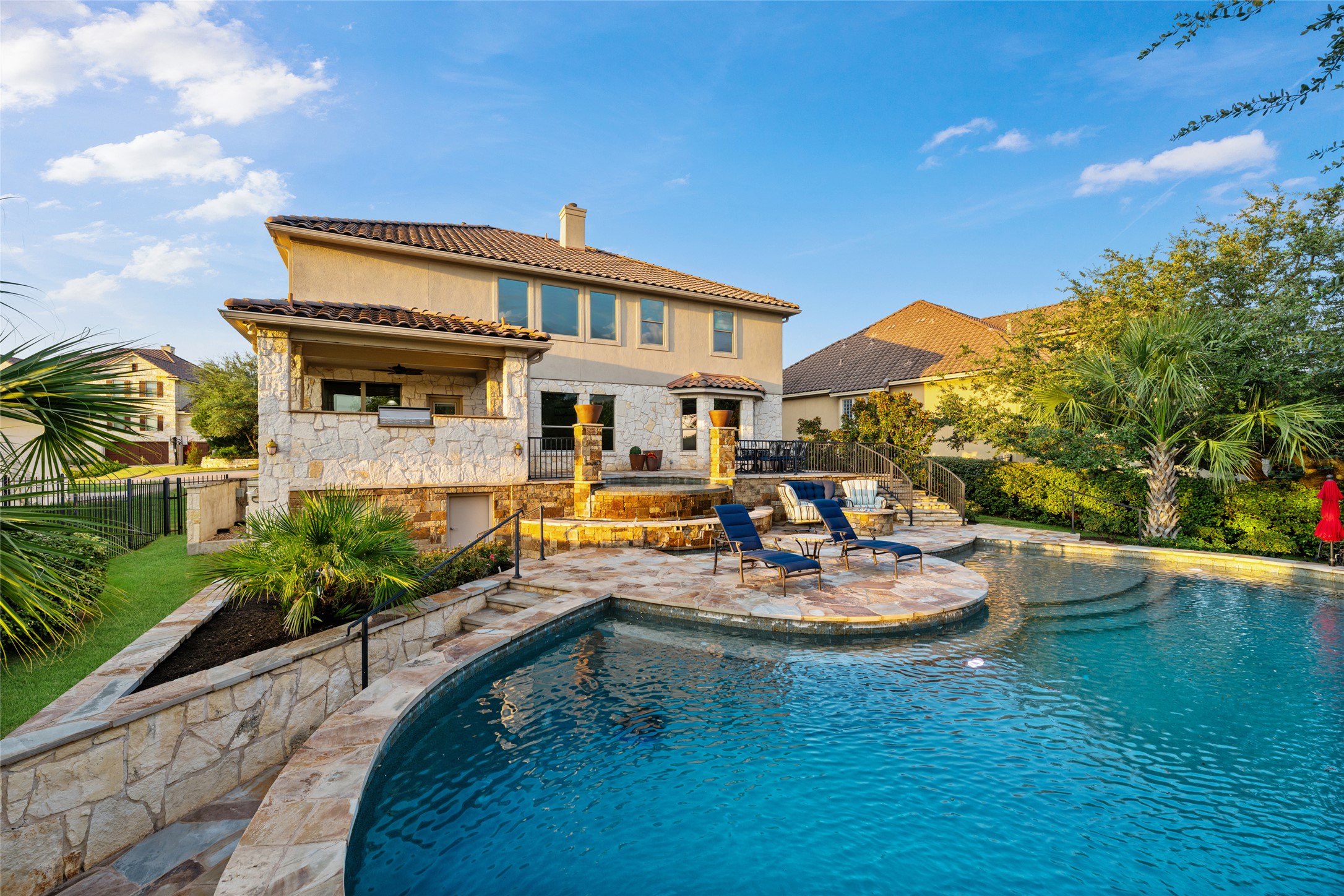 15205 Spillman Ranch Loop Austin, TX 78738 - Photo 6 of 40 A spacious, multi-level patio with an inviting in-ground pool and integrated spa, perfect for outdoor leisure.