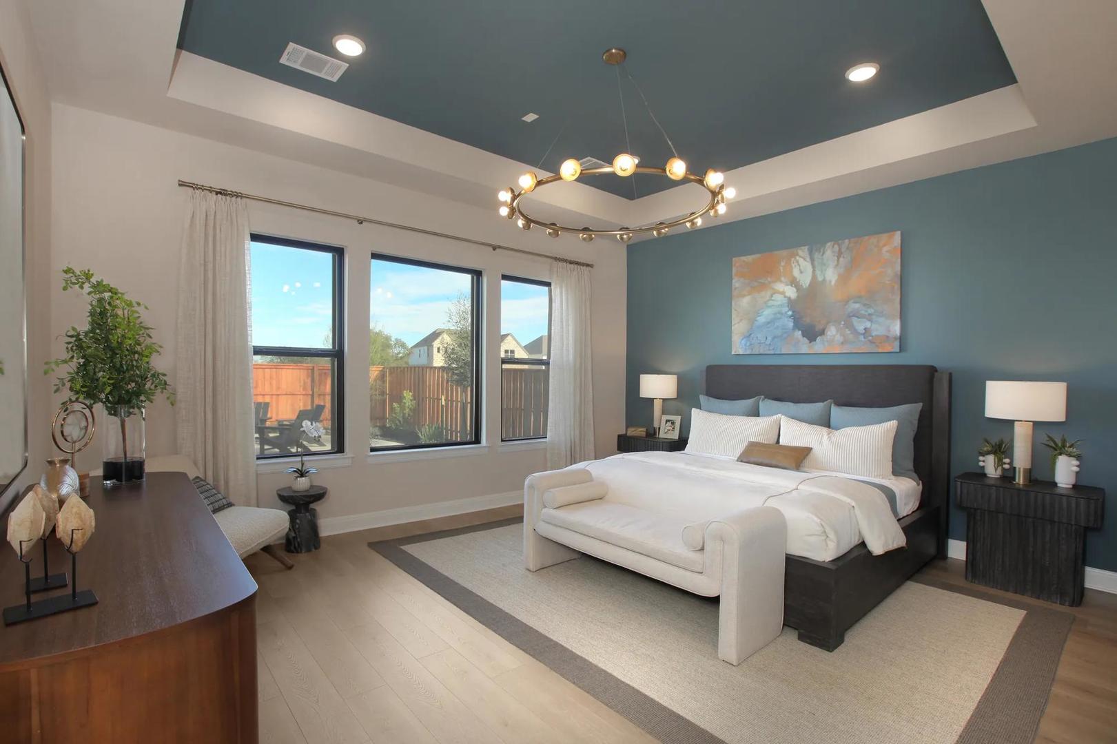 2033 Morning Mist Drive Georgetown, TX 78628 - Photo 24 of 36 a spacious bedroom with a large bed and a chandelier