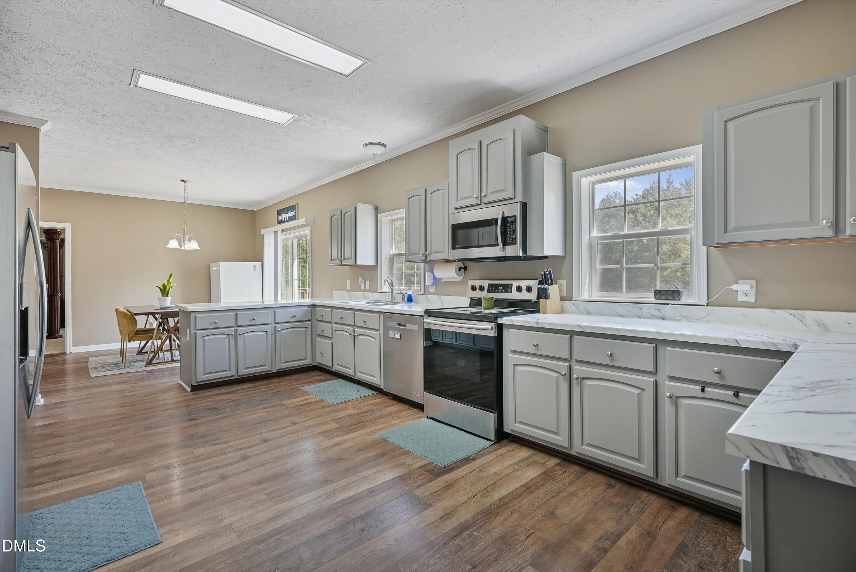700 Mann Road Coats, NC 27521 - Photo 12 of 35 a kitchen with granite countertop a sink cabinets and stainless steel appliances