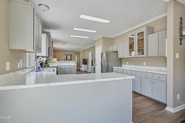 a large kitchen with kitchen island a sink stainless steel appliances and cabinets
