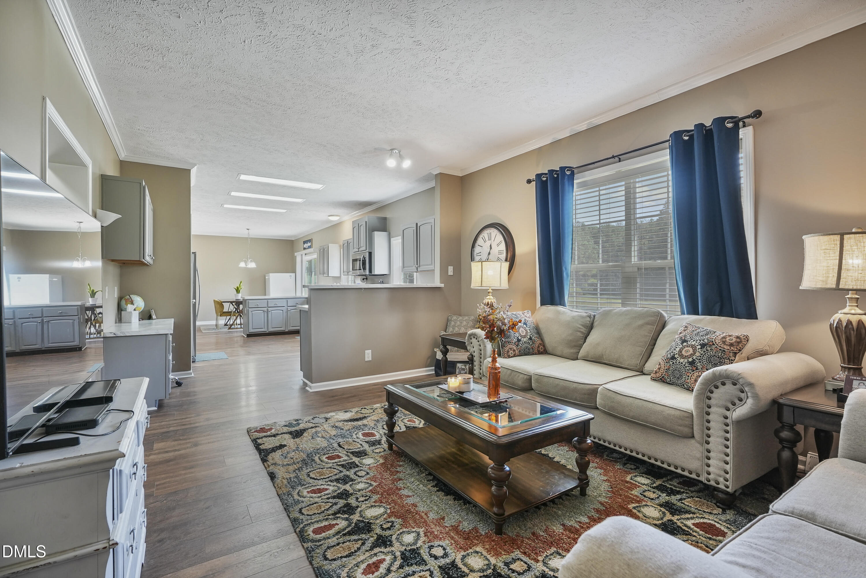 700 Mann Road Coats, NC 27521 - Photo 16 of 35 a living room with furniture wooden floor and a kitchen view