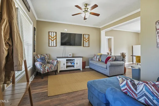 a living room with furniture and a flat screen tv