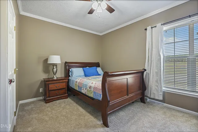 a bedroom with a bed and window