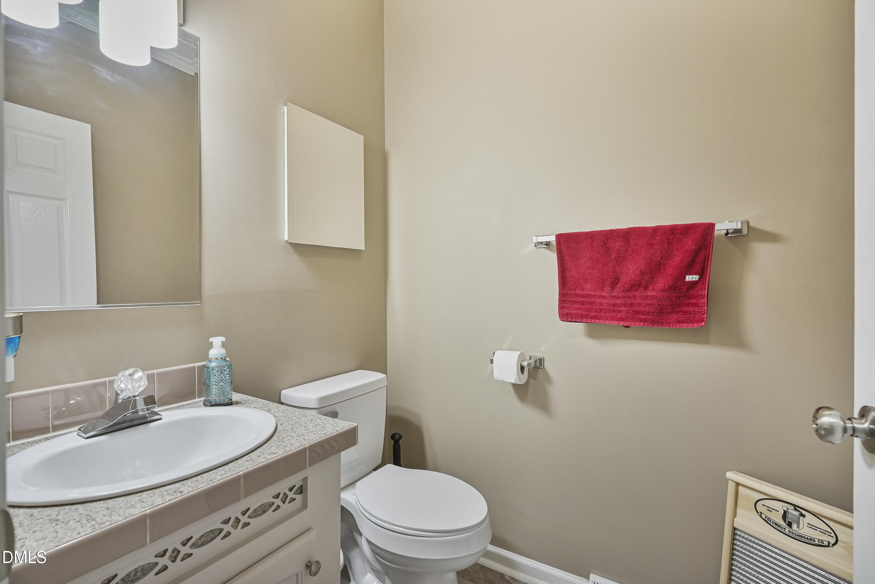 700 Mann Road Coats, NC 27521 - Photo 24 of 35 a bathroom with a toilet a sink and mirror