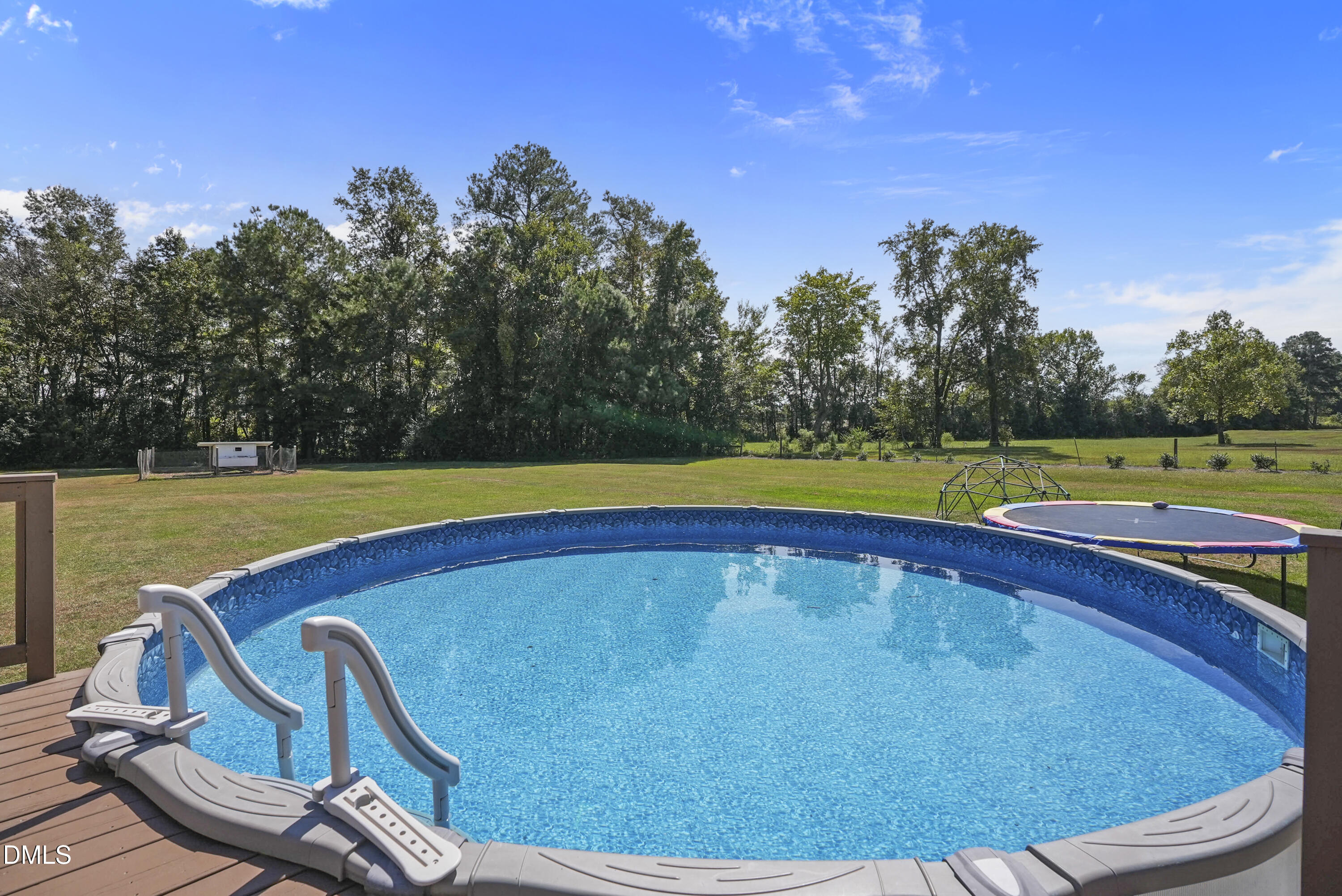 700 Mann Road Coats, NC 27521 - Photo 29 of 35 a view of a swimming pool with an outdoor space and seating area