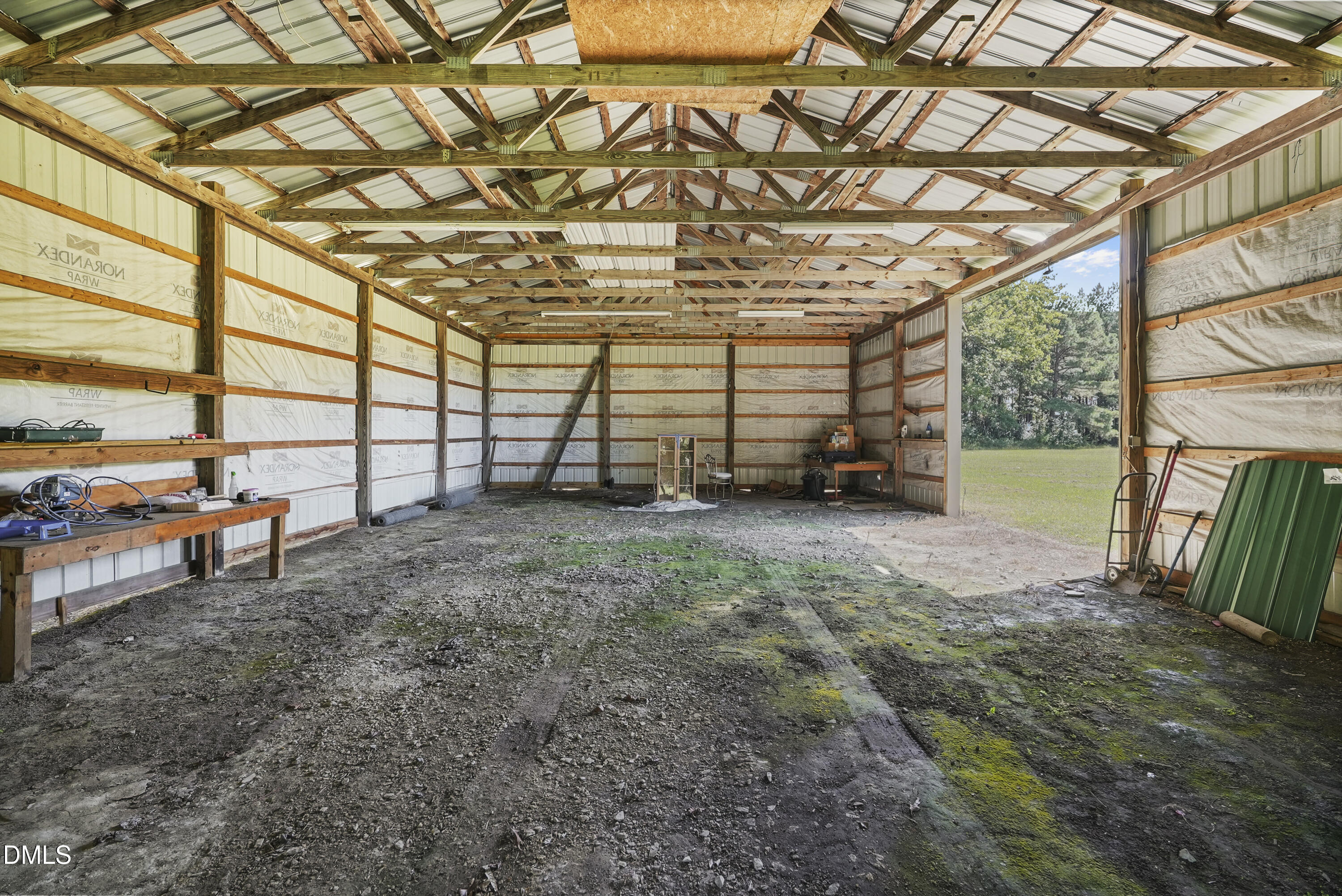 700 Mann Road Coats, NC 27521 - Photo 32 of 35 a view of an empty room with a wooden floor and a bench