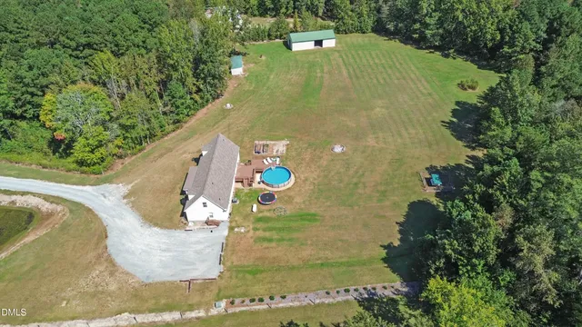 a aerial view of a house with swimming pool and outdoor space
