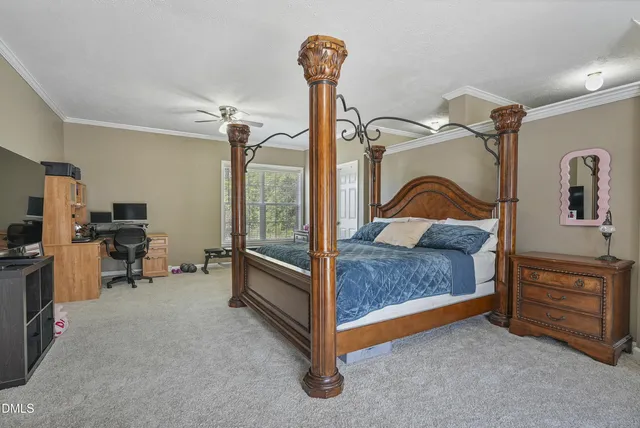 a bedroom with a bed and a tv on the dresser