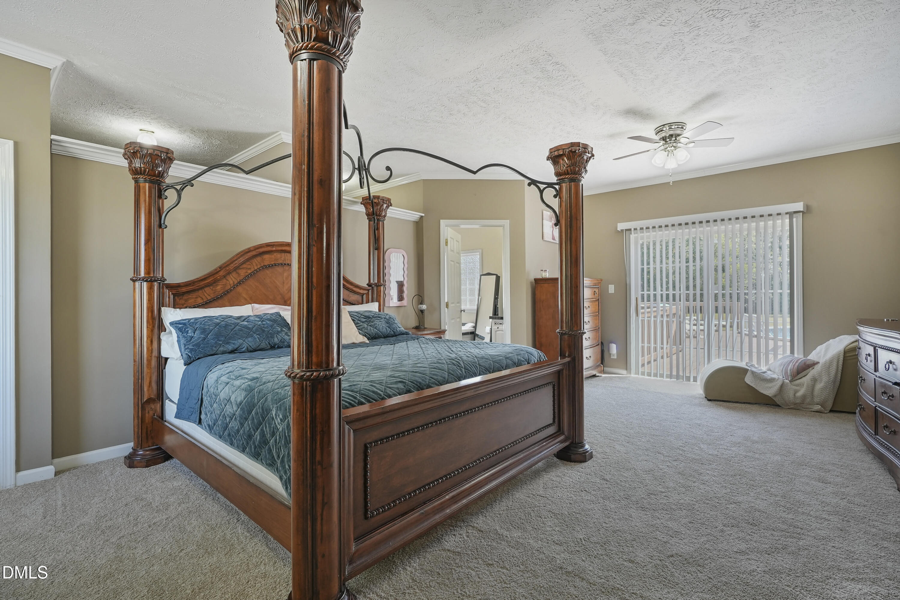 700 Mann Road Coats, NC 27521 - Photo 7 of 35 a bedroom with a bed and a chandelier