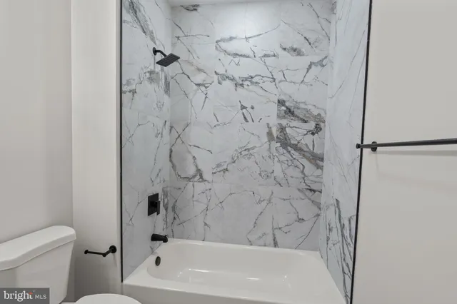 a bathroom with a bathtub and a toilet