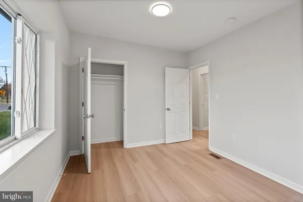 a view of a room with wooden floor and windows