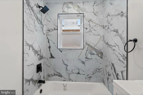 a bathroom with a bathtub and shower