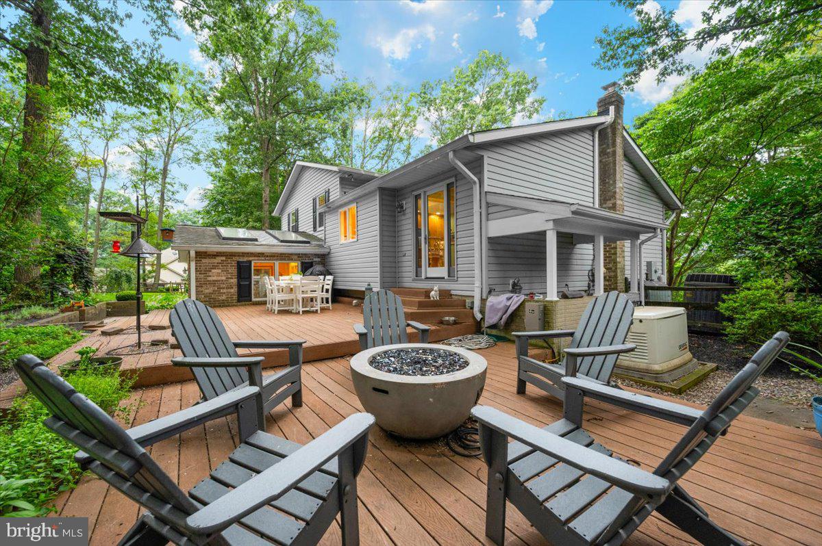 5105 Fleming Road Mount Airy, MD 21771 - Photo 54 of 73 a view of a patio with table and chairs potted plants and a large tree
