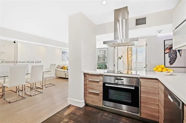 a kitchen with stainless steel appliances kitchen island granite countertop a stove and a sink
