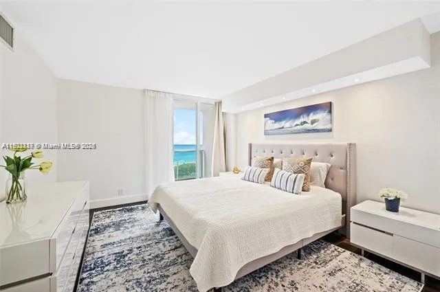 a bedroom with a large bed and a couch