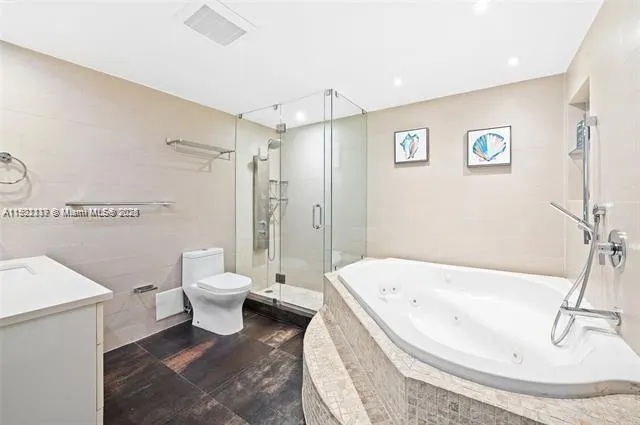 a white bath tub sitting next to a white toilet