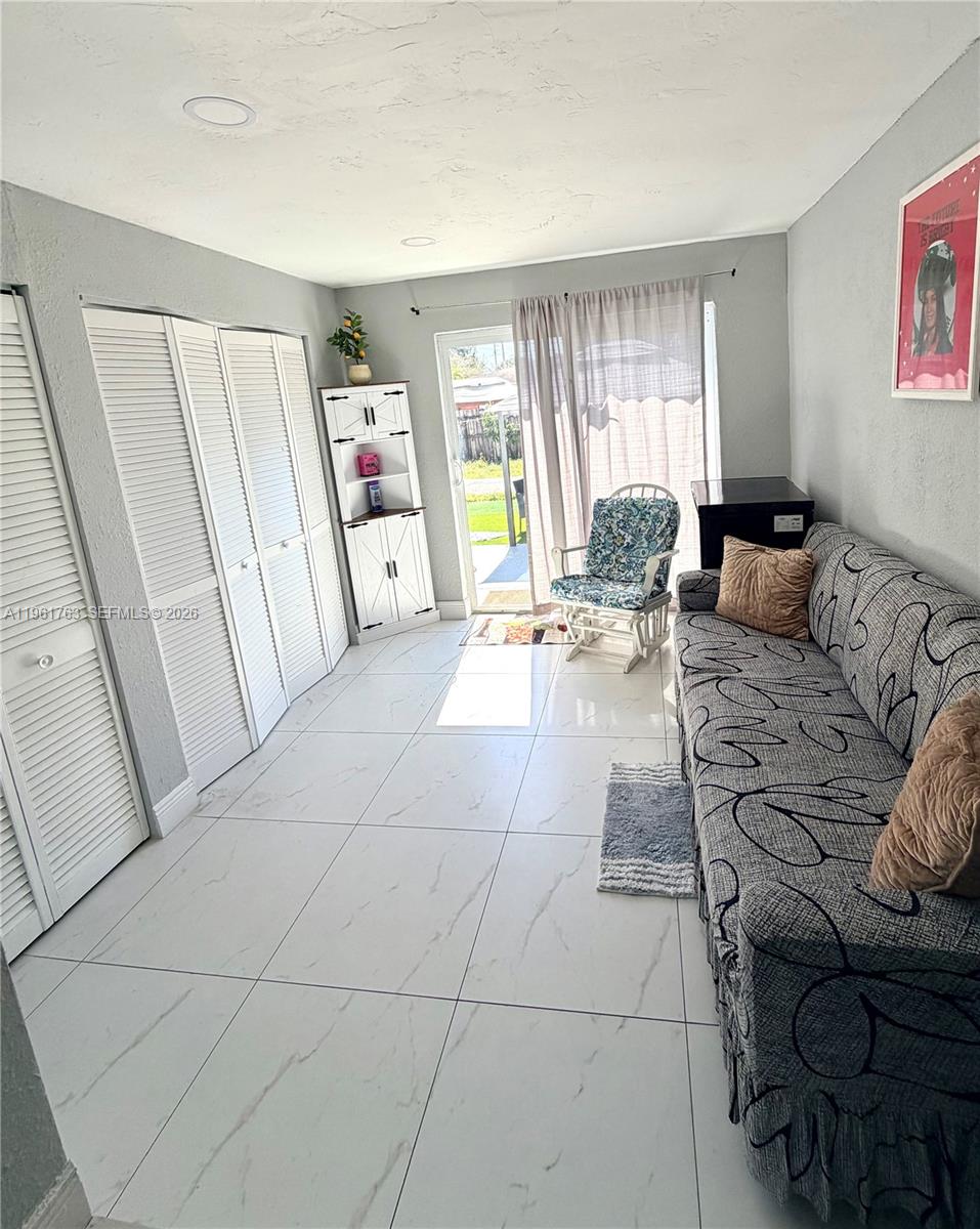 598 East 41st Street Hialeah, FL 33013 - Photo 12 of 15 a living room with furniture and a large window