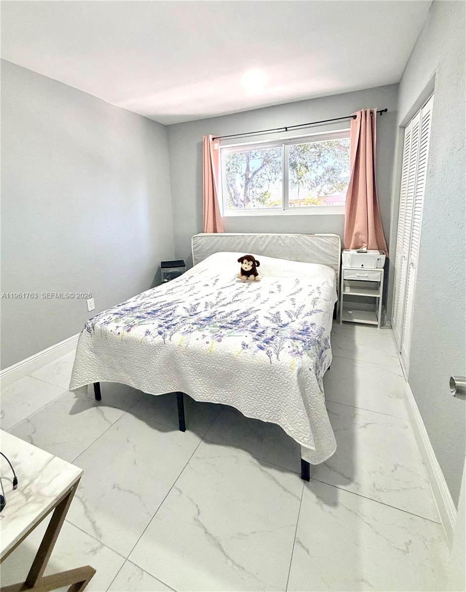 598 East 41st Street Hialeah, FL 33013 - Photo 7 of 15 a bed sitting in a bedroom next to a window