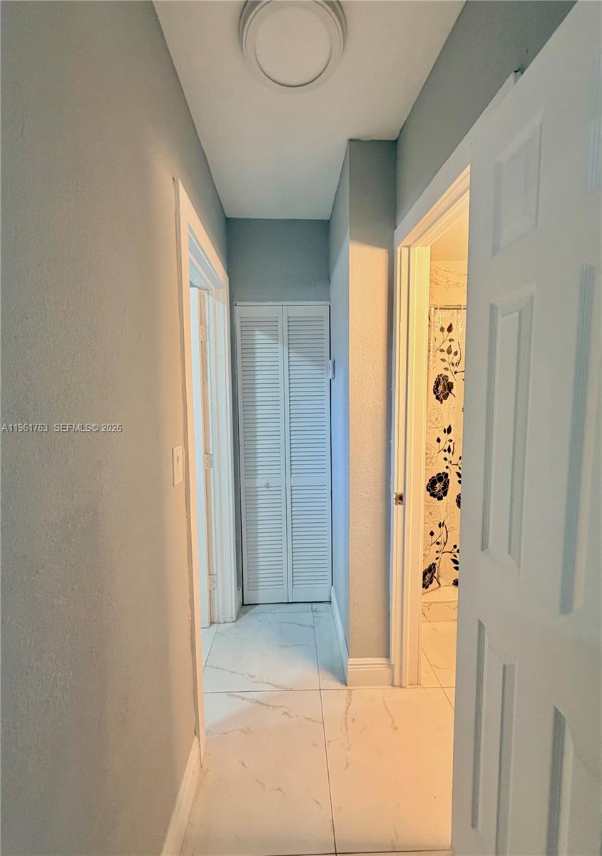 598 East 41st Street Hialeah, FL 33013 - Photo 8 of 15 a view of a hallway with windows and closet