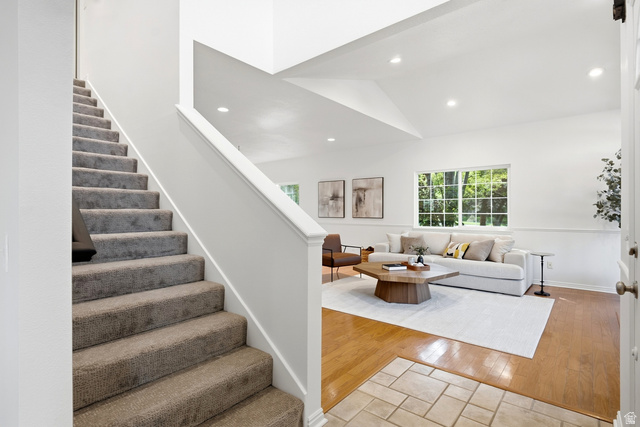 1462 Rio Grande Road Park City, UT 84098 - Photo 13 of 30 Carpeted staircase with white balustrade, wood-finish flooring, tiled entry, and vaulted ceilings with recessed lighting
