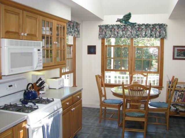75 Jennie Clark Road Eastham, MA 02642 - Photo 8 of 23 a view of a dining room with furniture a chandelier and wooden floor