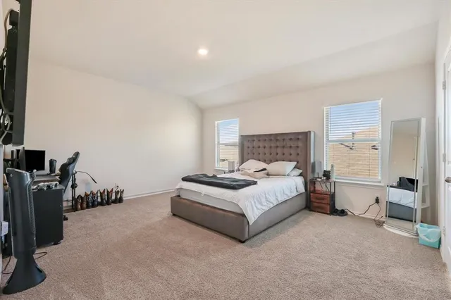 a spacious bedroom with a bed and a couch