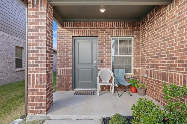 a backyard of a house with outdoor seating