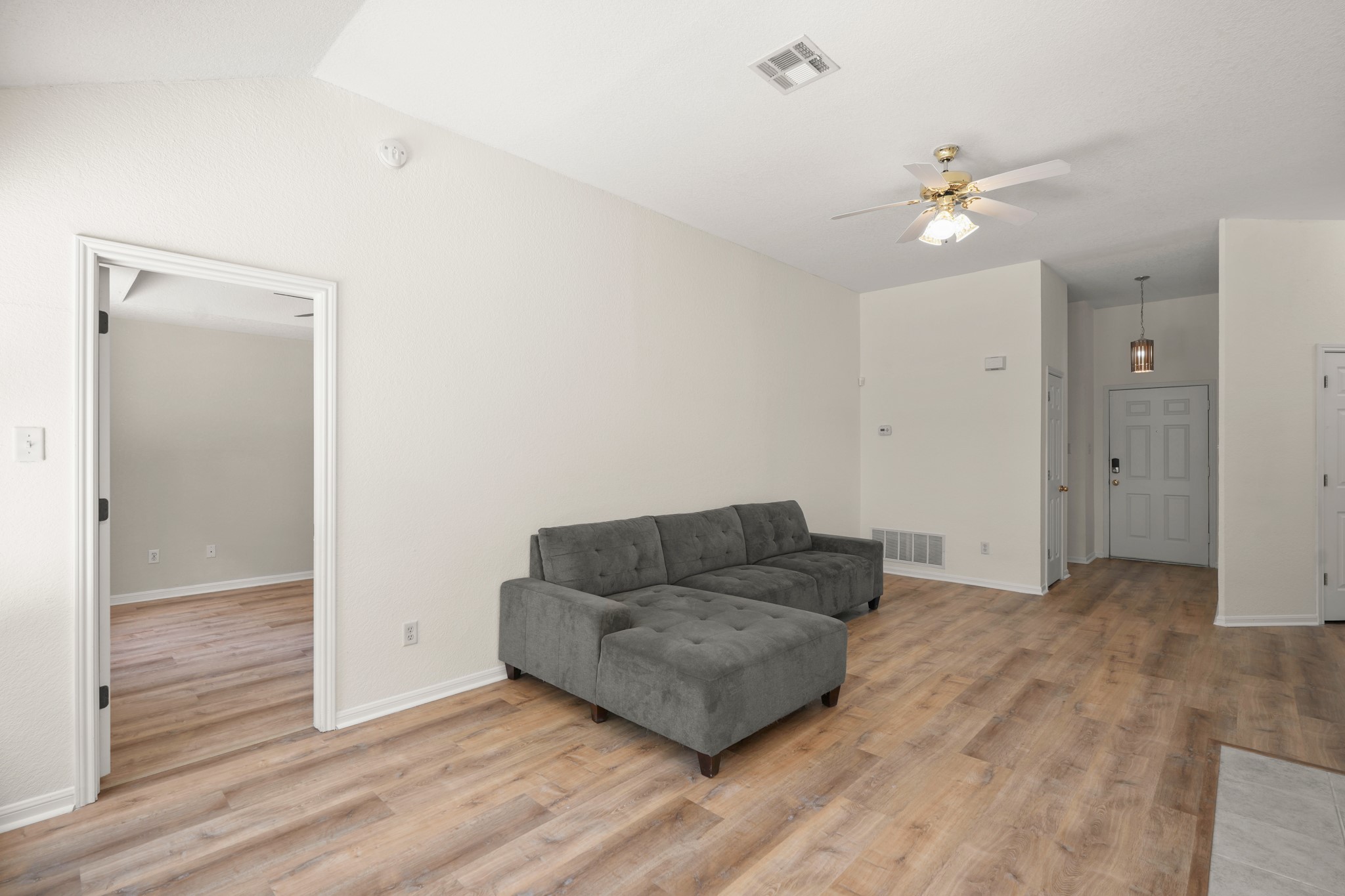 438 Katy Crossing Georgetown, TX 78626 - Photo 10 of 24 A welcoming living area showcases durable wood-look flooring and a soaring vaulted ceiling.