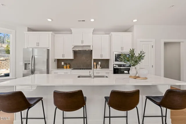a kitchen with kitchen island cabinets and refrigerator