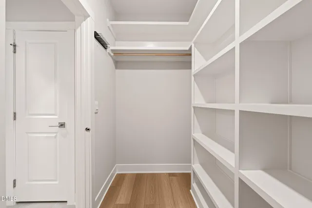 a view of walk in closet with empty racks
