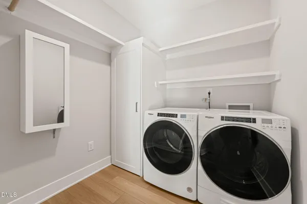 a view of a hallway with washer and dryer