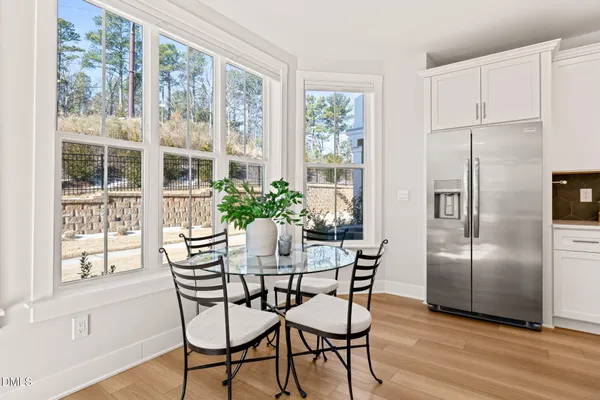 a dining room with furniture window and wooden floor