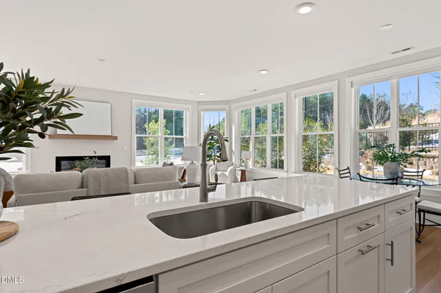 a kitchen with a sink and a large window