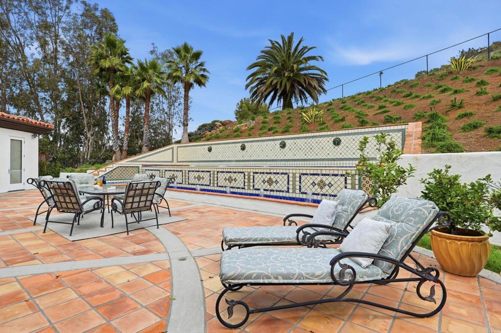 3244 Olivenhain Farms Road Encinitas, CA 92024 - Photo 44 of 47 a view of a swimming pool with a table and chairs