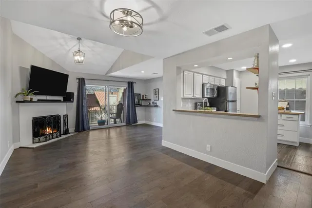 a view of kitchen with livingroom and fireplace