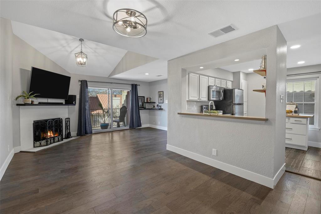 a view of kitchen with livingroom and fireplace