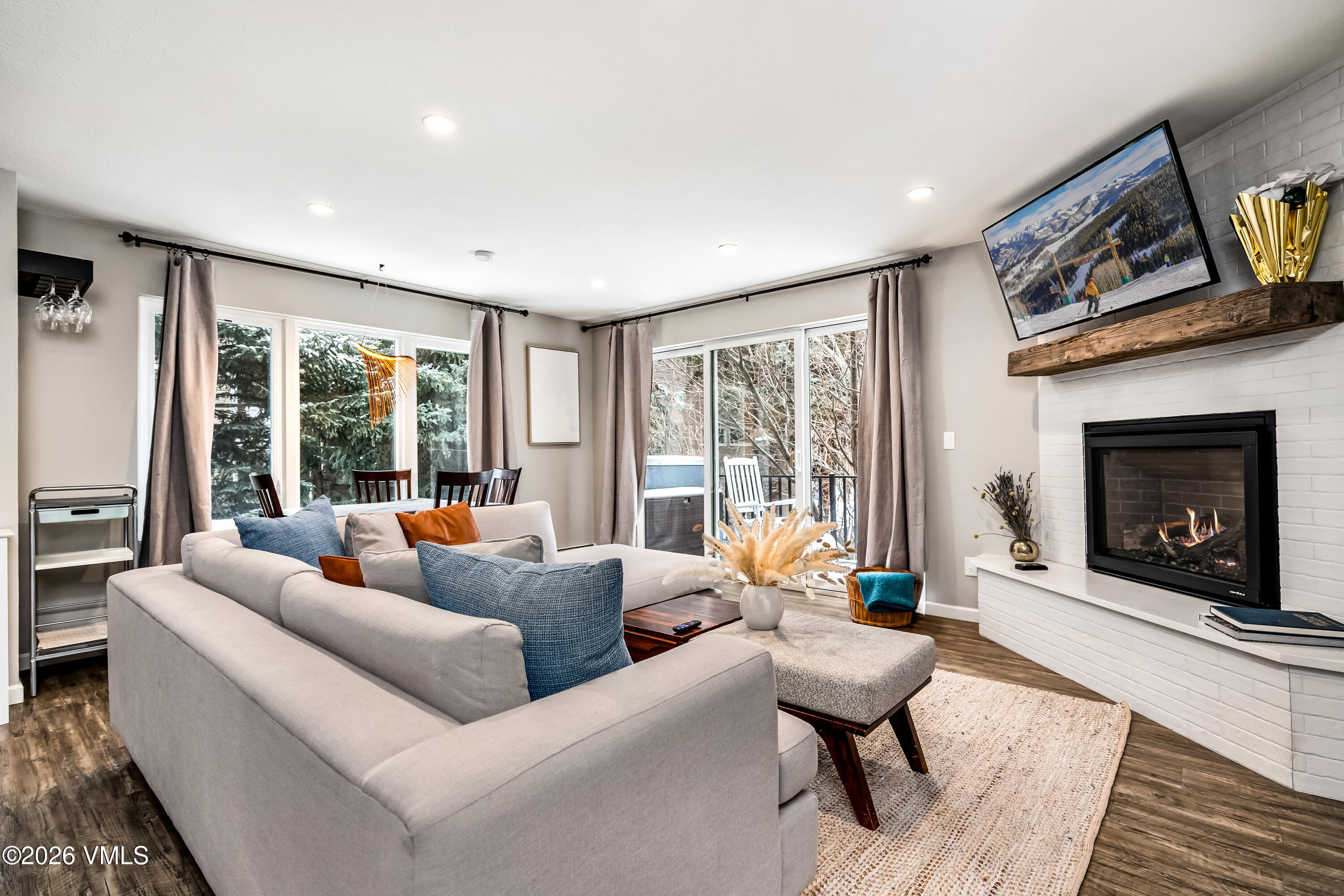 212 Eagle Road Eagle-Vail, CO 81620 - Photo 1 of 25 a living room with furniture large window and a fireplace
