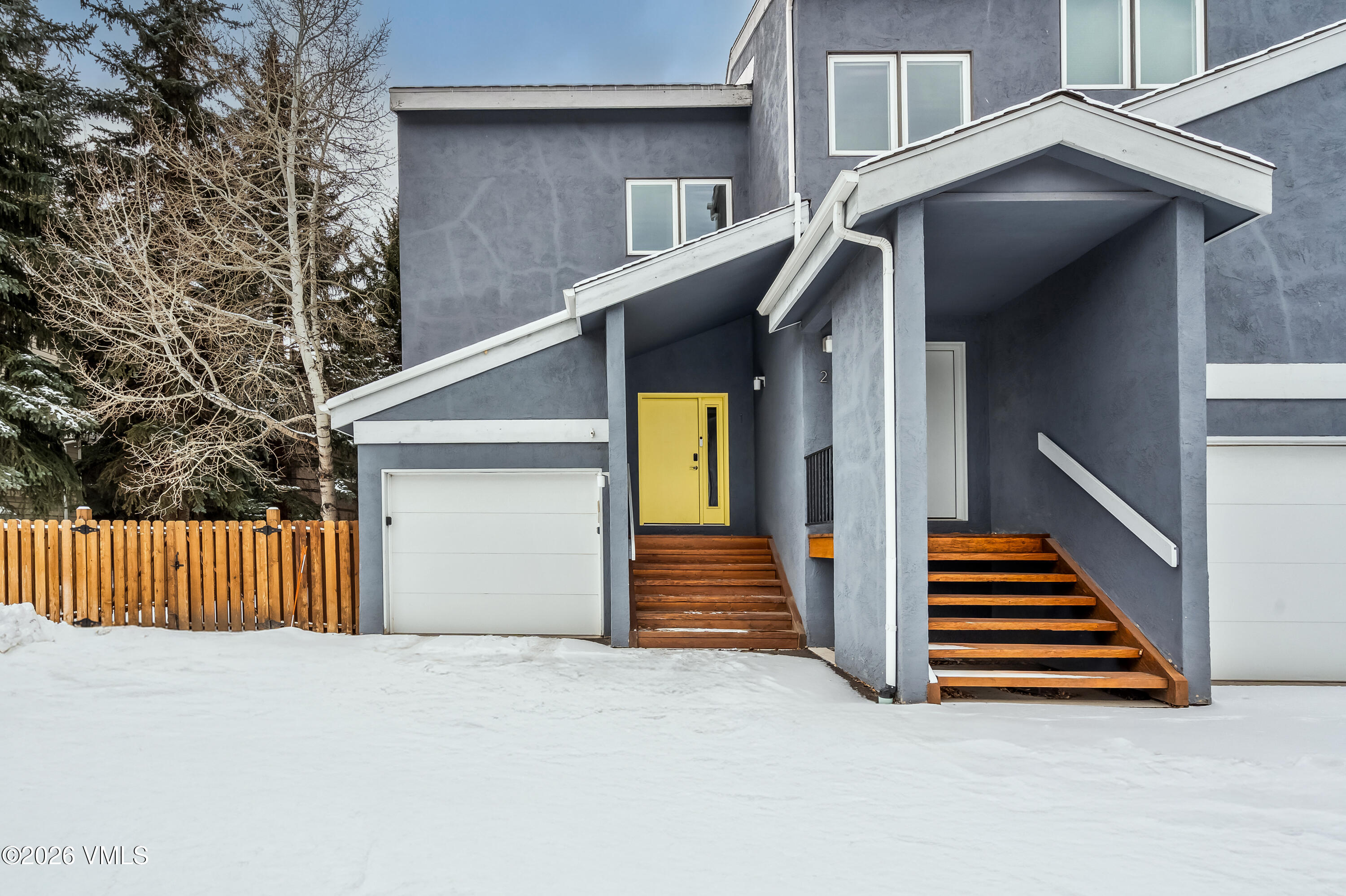 212 Eagle Road Eagle-Vail, CO 81620 - Photo 24 of 25 a front view of a house with stairs and wooden fence