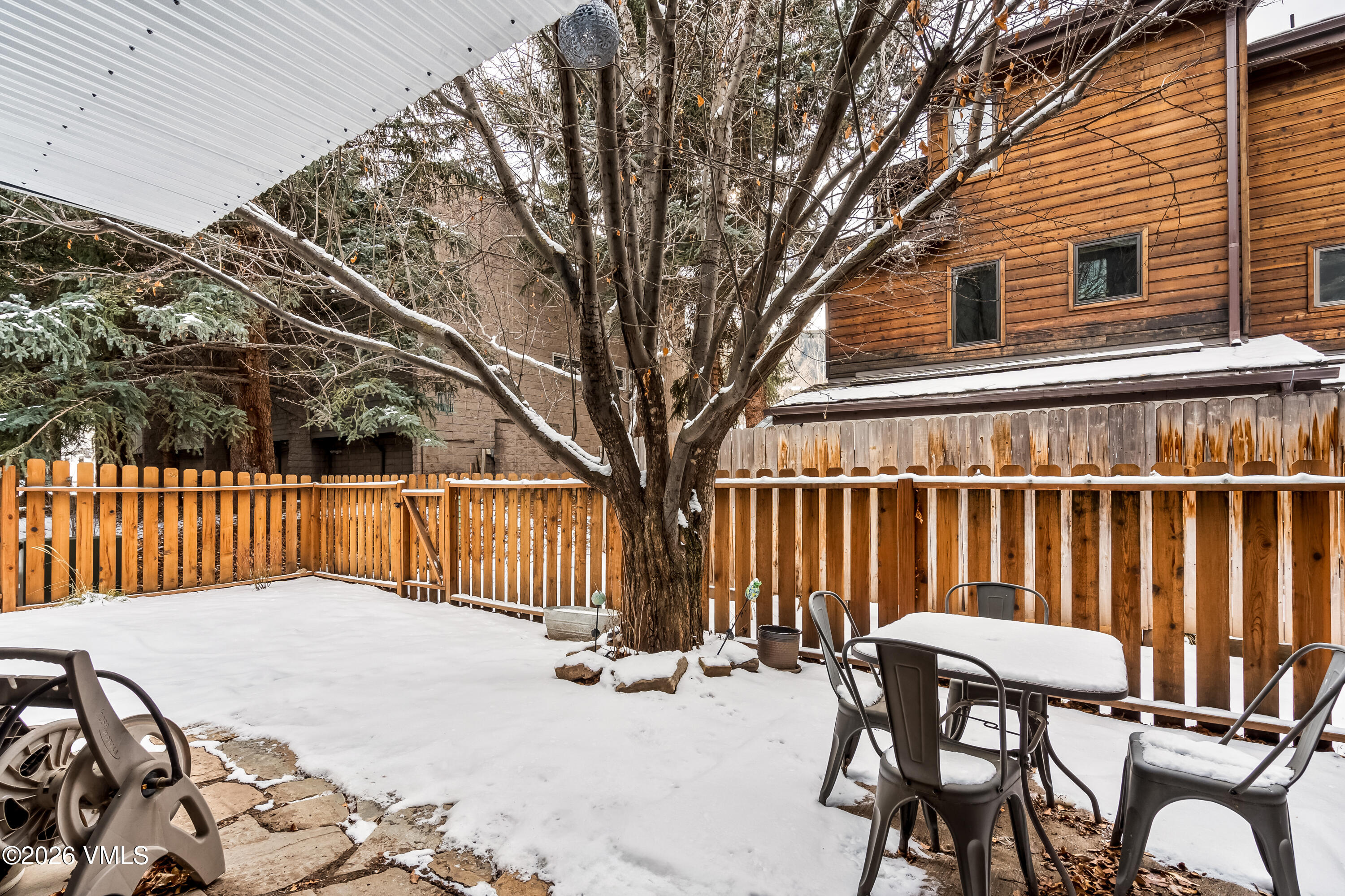 212 Eagle Road Eagle-Vail, CO 81620 - Photo 4 of 25 a view of balcony with two chairs and a large tree