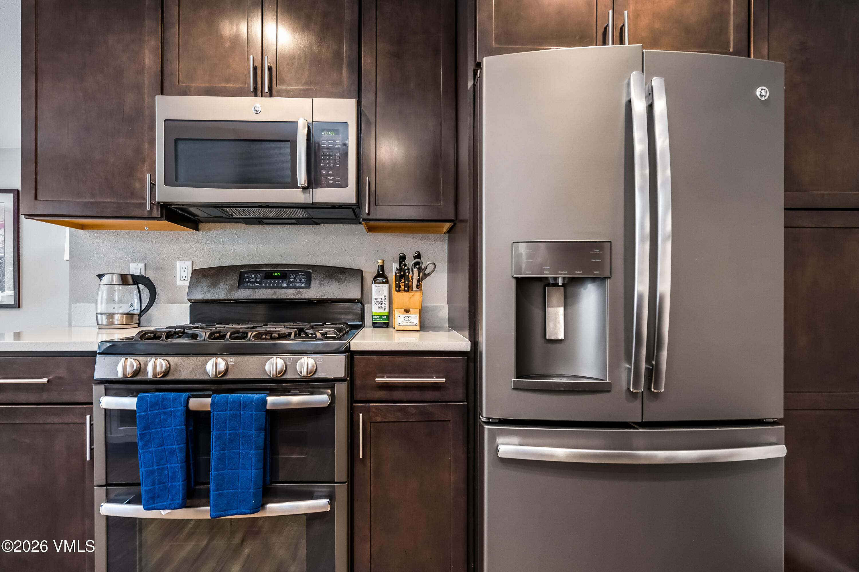 212 Eagle Road Eagle-Vail, CO 81620 - Photo 10 of 25 a kitchen with stainless steel appliances granite countertop a stove and a refrigerator